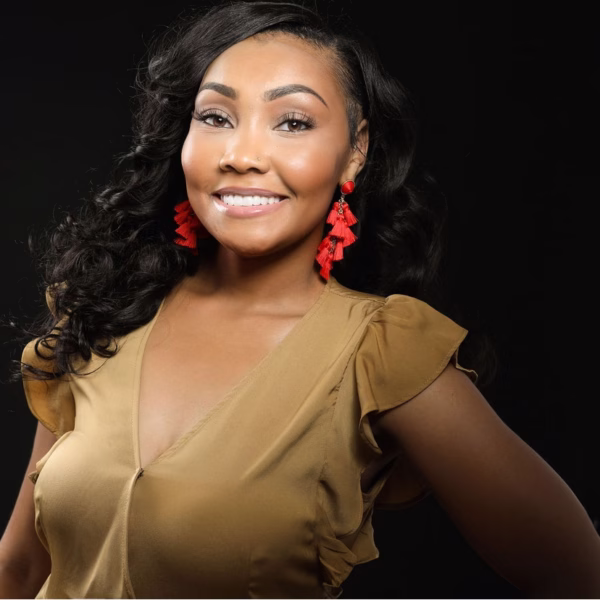 smiling woman with bright white teeth wearing red tassel earrings and gold top showcasing a beautiful cosmetic dentistry smile result at Georgetown Cosmetic Dentistry in Washington DC